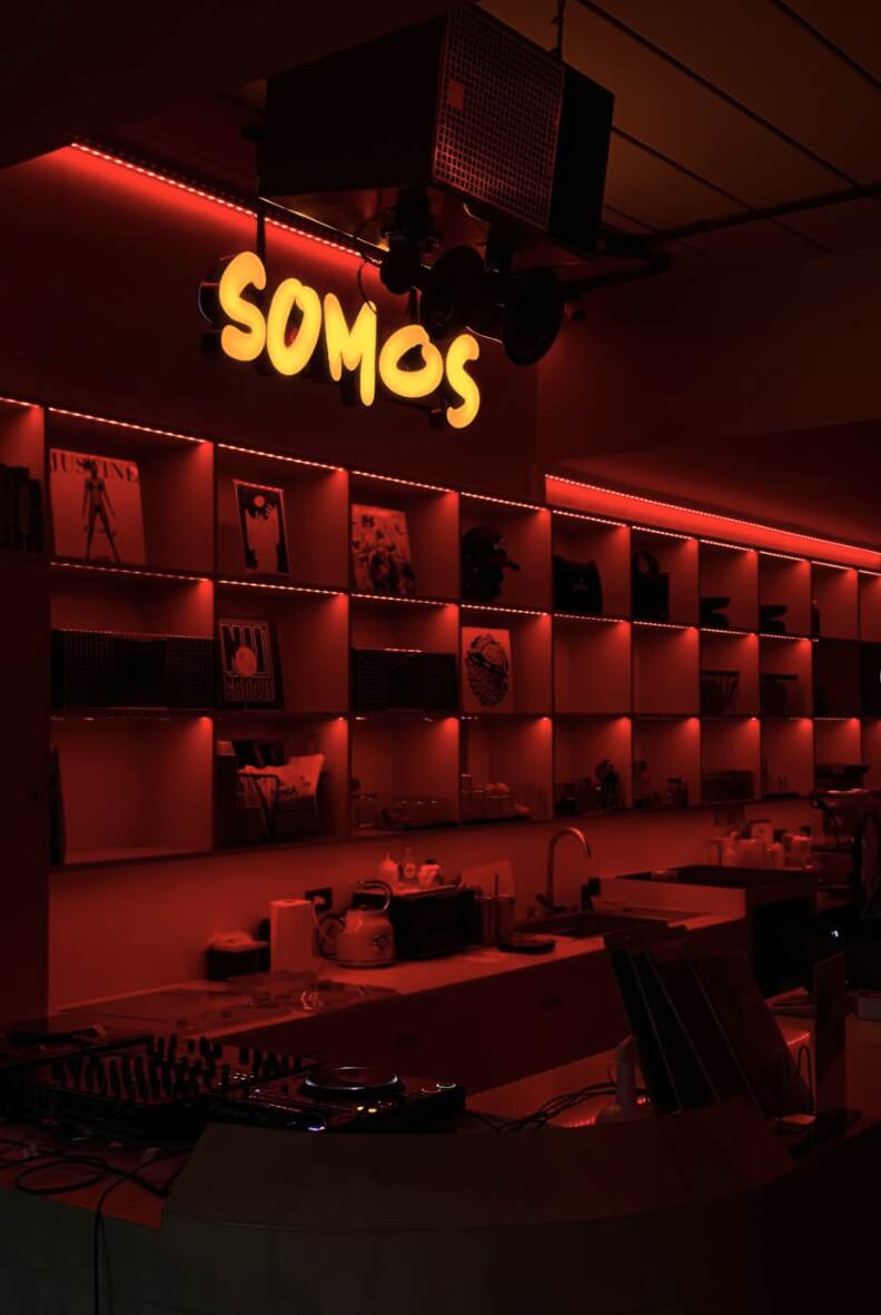 The Somos bar under red neon after dark